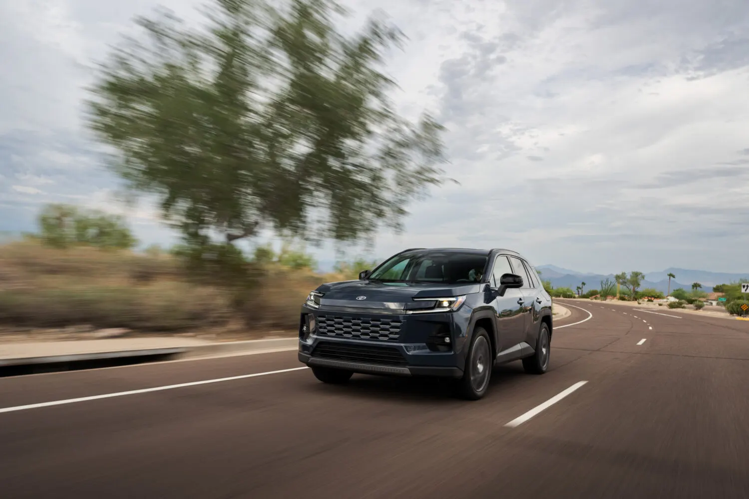2026 Toyota RAV4 2.5L Hybrid AWD Luxury — driving on the road